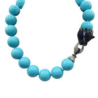 Collier en turquoise à base de coquillage avec fermoir lion en argent sterling et saphir