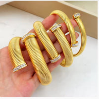 Gold Plated Twelve Millimeter Cobra Bracelet With Pave Tips